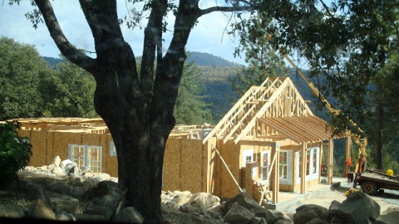 panelized kit home package being assembled on site with normal stick built framing